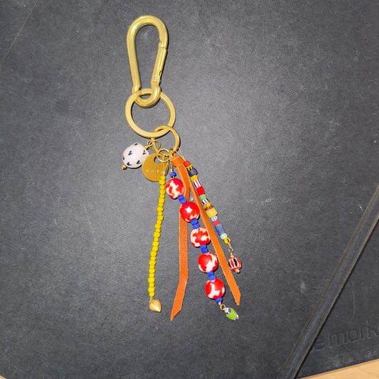 Colorful keychain with beads and leather on a dark surface