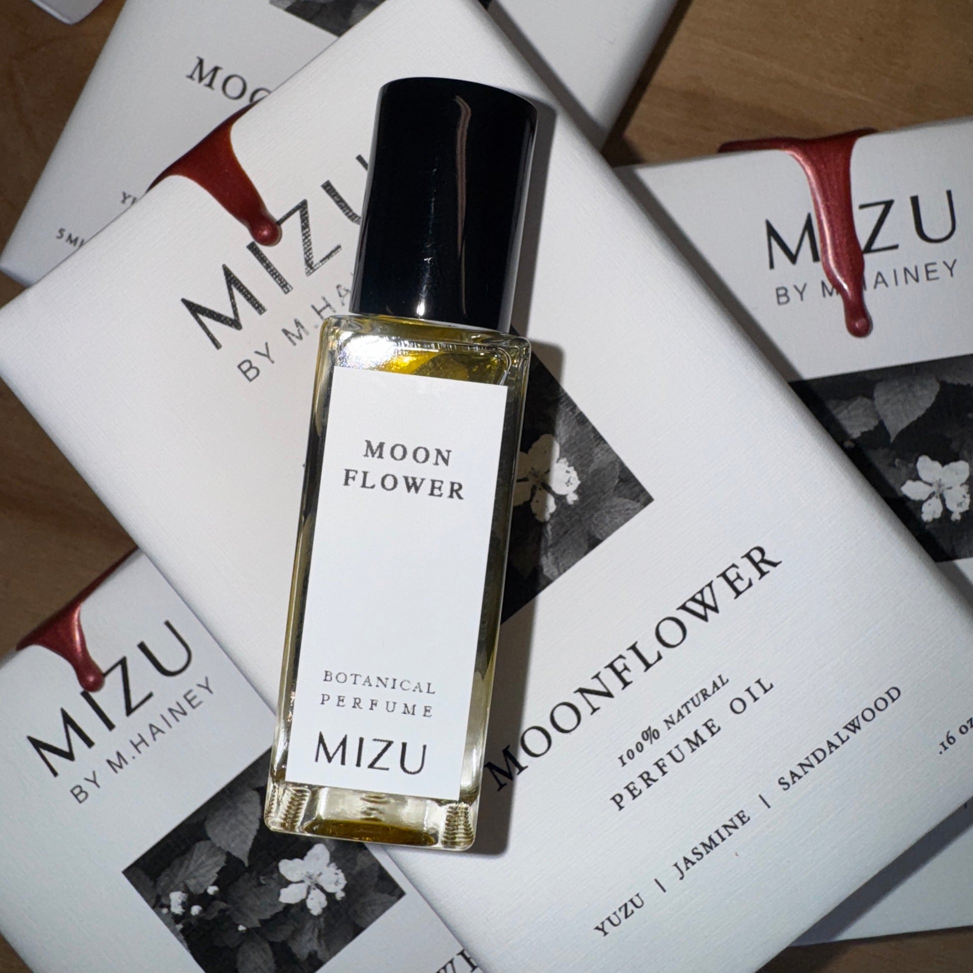 Mizu Moon Flower perfume bottle on top of Mizu packaging