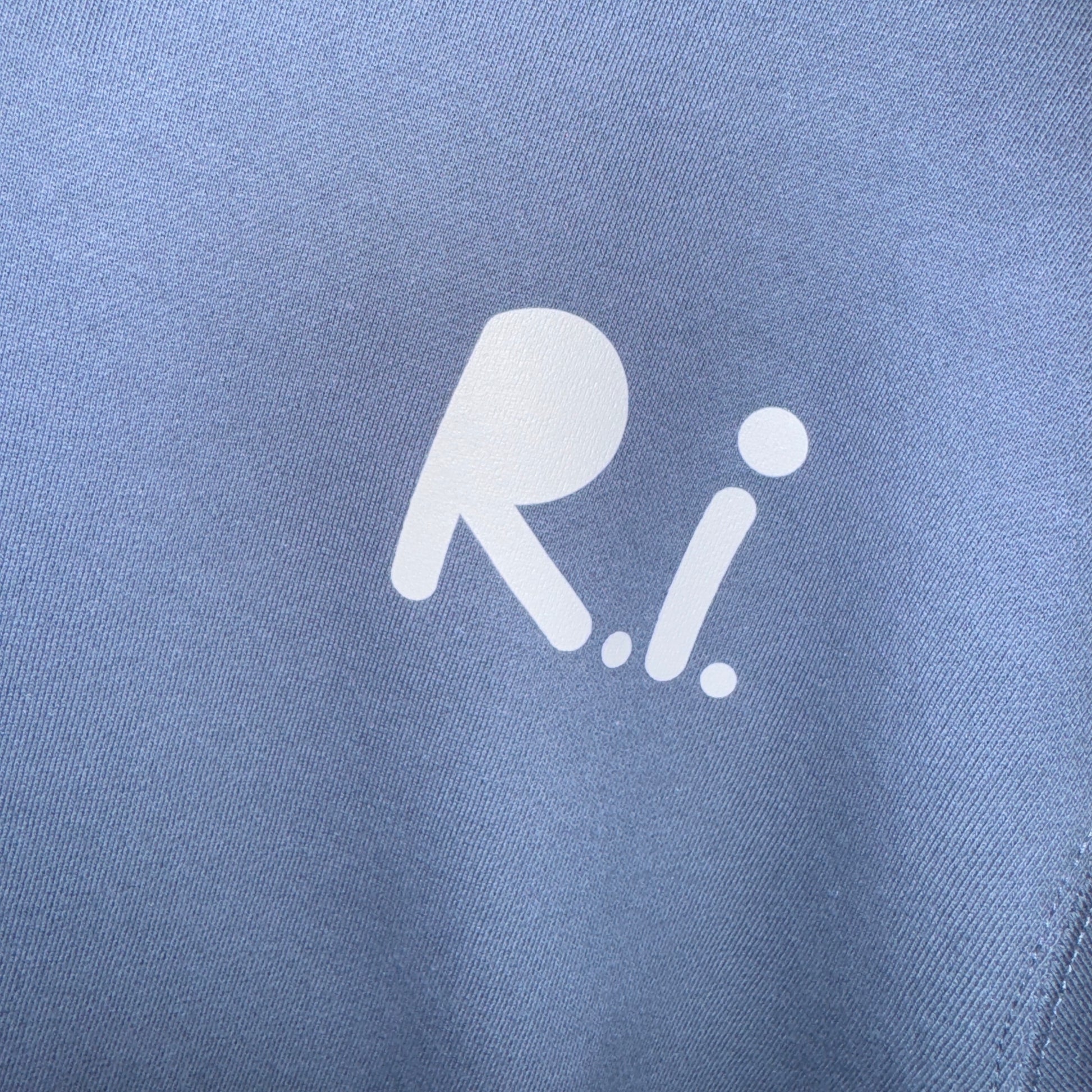 Close-up of a blue fabric with a white logo on a blue background
