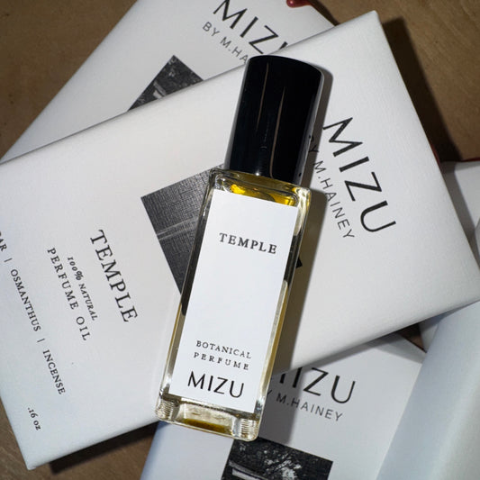 Mizu Temple botanical perfume bottle on a stack of Mizu boxes