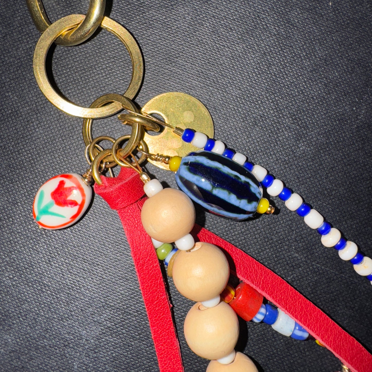 Keychain with beads and charms on a dark background